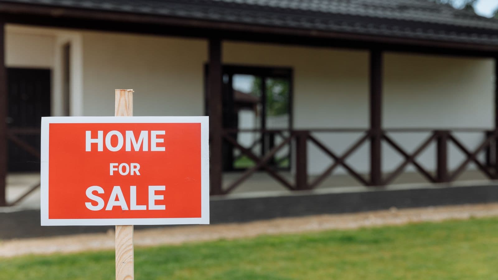 House with a for-sale sign on the front lawn, listed the traditional way