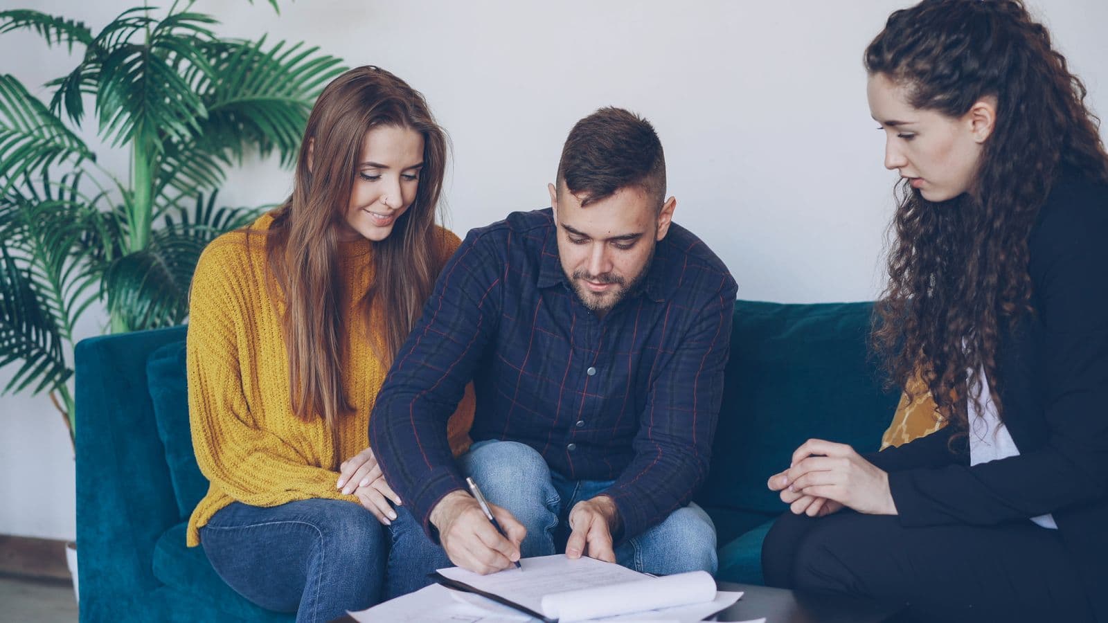 Homeowners reviewing loan paperwork with an advisor before a foreclosure deadline