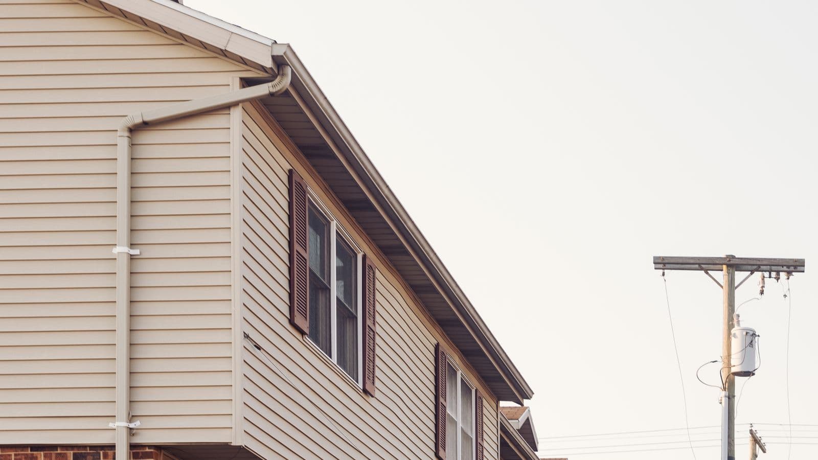 Row of brick and siding rental townhomes in a residential neighborhood