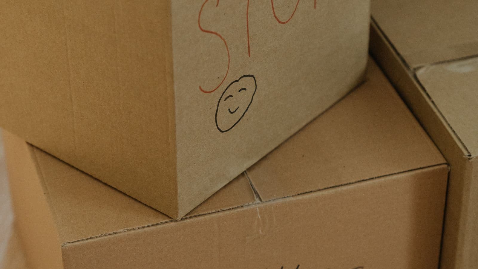Labeled cardboard moving boxes packed and stacked for a move